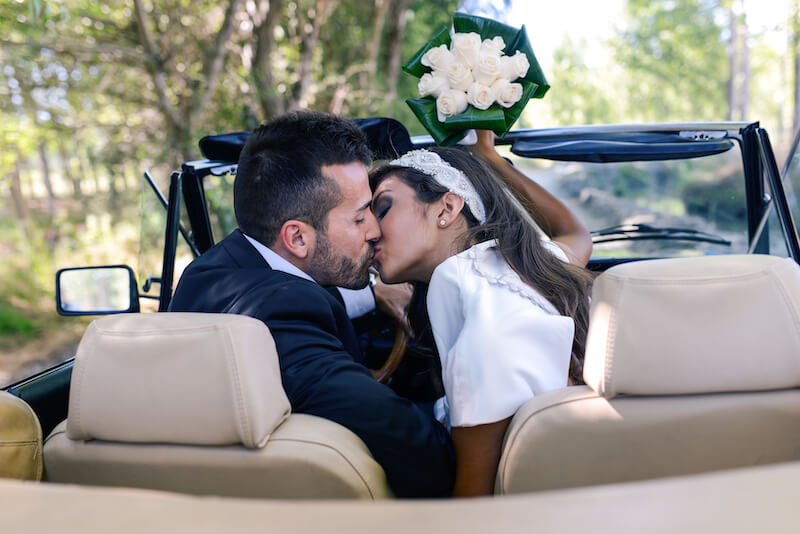 couple in wedding car kissing couple in wedding car kissing